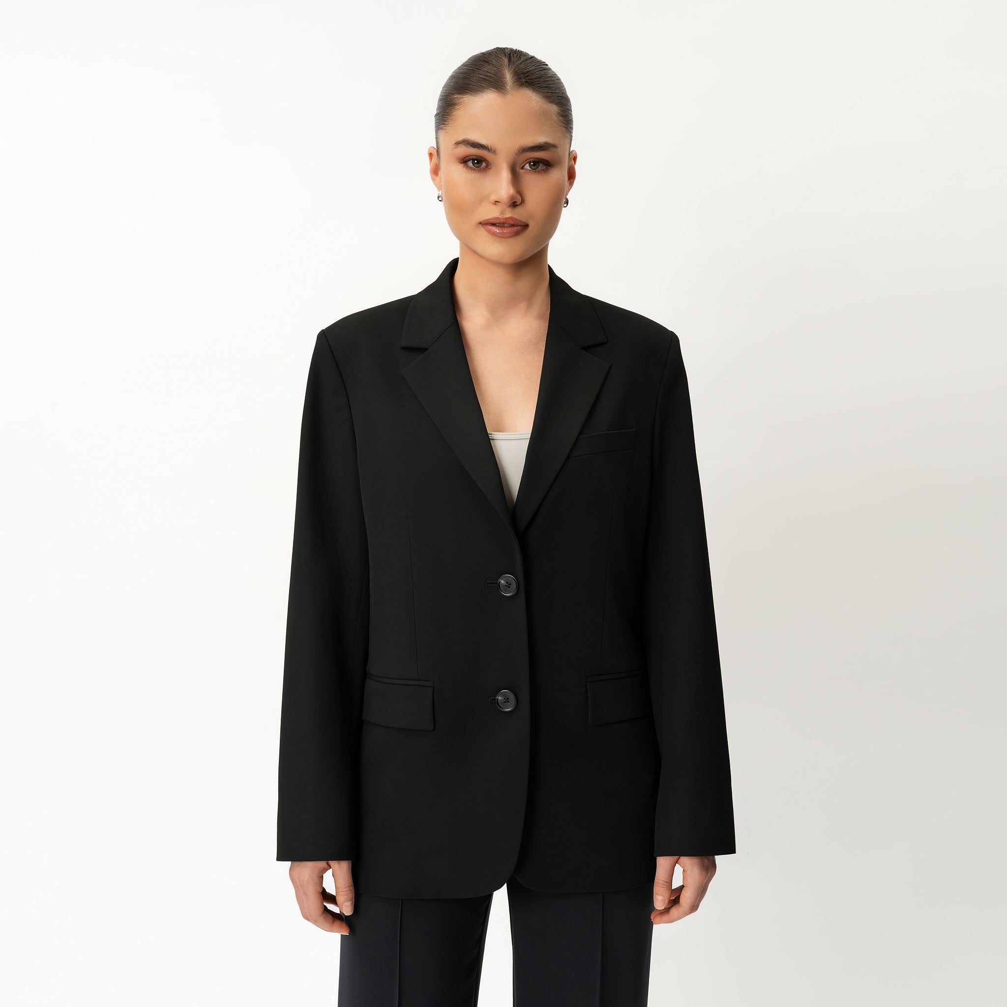 Person wearing Ninepine black blazer on a white background