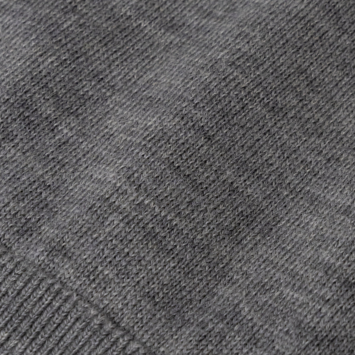 Close-up of heather grey Ninepine merino wool fabric texture.